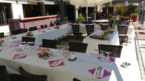 a group of tables with pink napkins on them at Casa Marana by Le Lido in Lucciana