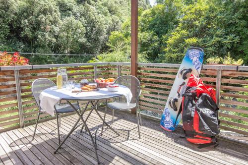 a table and a snowboard sitting on a deck at Sweet Laghel Apartments in Arco
