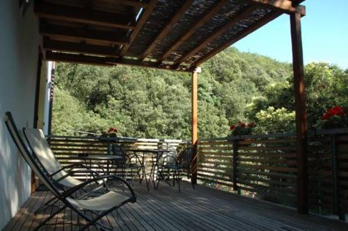 a deck with chairs and tables on a porch at Sweet Laghel Apartments in Arco