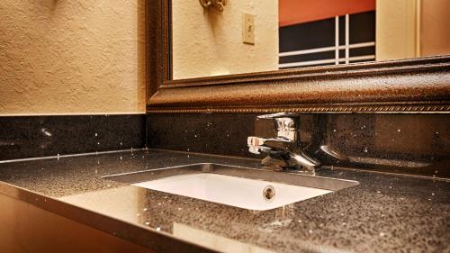 a bathroom with a sink and a mirror at Best Western Gardendale in Gardendale