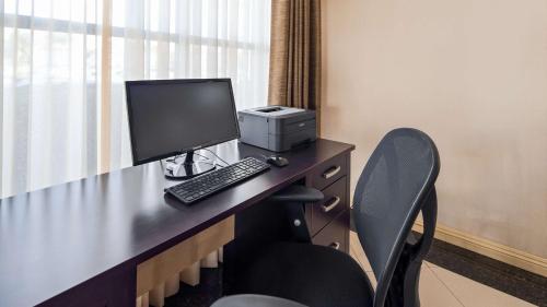 a desk with a computer monitor and a printer at Best Western Norwalk Inn in Norwalk