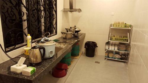a kitchen with a counter with pots and pans at Golden Hill 34 in Cameron Highlands