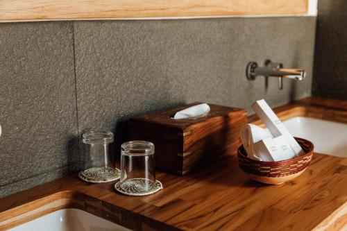 a kitchen counter with a sink and a wooden counter top at Hemingways Retreat Kigali in Kigali