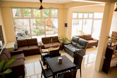 a living room with a couch and a table at Hulhan'gu Lodge in Himmafushi