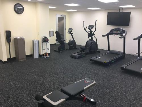 a gym with several exercise bikes and a flat screen tv at Best Western Plus Arrowhead Hotel in Colton