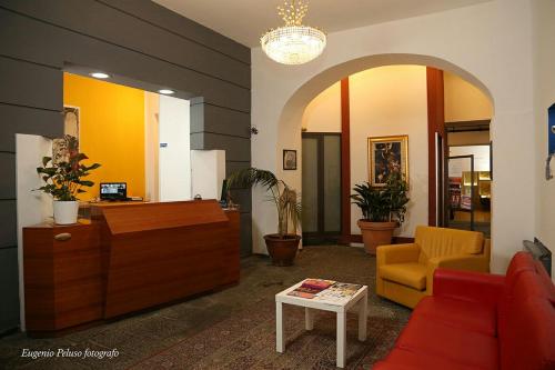 a lobby with a waiting room with a couch and a table at Caravaggio Hotel in Naples