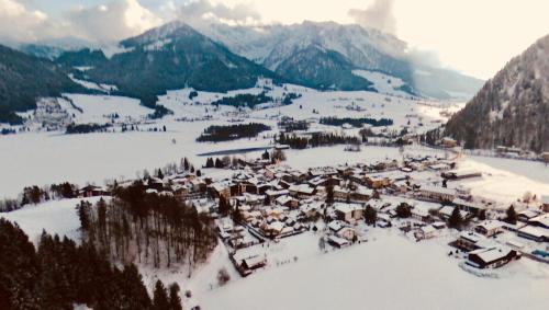 an aerial view of a village in the snow at Mountain Inn Chalets & Apartments in Walchsee