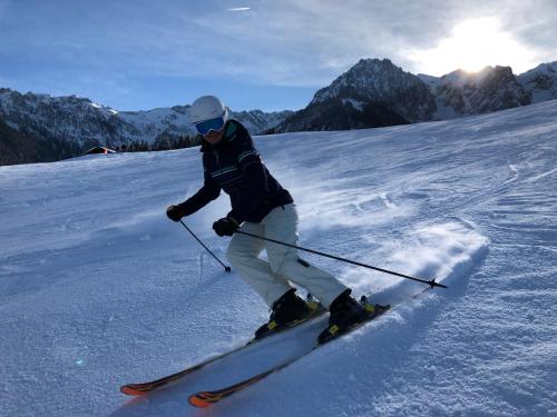 a person is skiing down a snow covered slope at Mountain Inn Chalets & Apartments in Walchsee