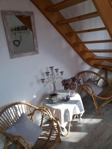 a room with a table with chairs and a mirror at Le Coq En Pate in Péronne