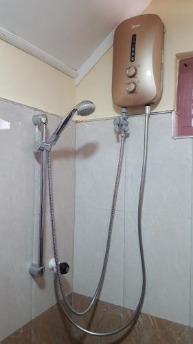 a shower in a bathroom with a shower head at Tulip Guest Inn in Point Pedro