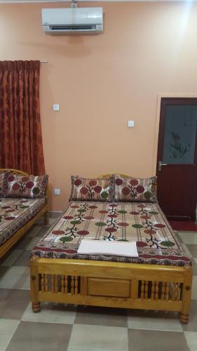 a bed in a room with a couch at Tulip Guest Inn in Point Pedro