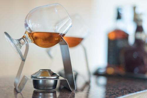 a glass of wine sitting on a table at Constantinou Bros Asimina Suites Hotel in Paphos City