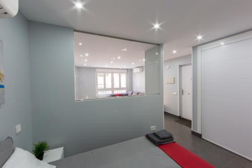 a bedroom with a large mirror on the wall at WindRose 4 in Madrid