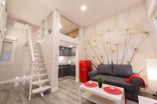 a living room with a staircase and a couch at WindRose 5 in Madrid