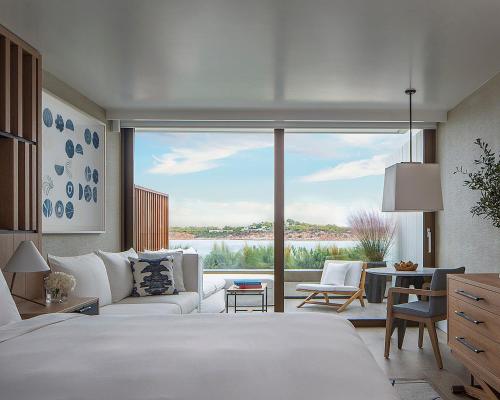 a bedroom with a white bed and a large window at Four Seasons Astir Palace Hotel Athens in Athens