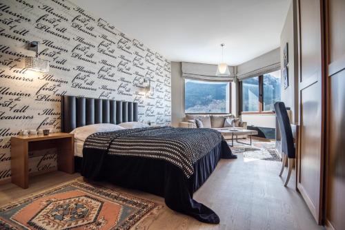 a bedroom with a wall covered in writing at Forest Suites Boutique Hotel in Méga Khoríon