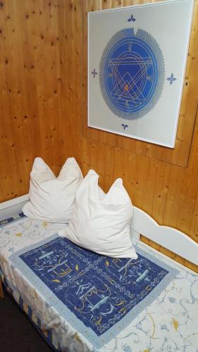 a bed with two pillows and a painting on a wall at Apartments Almstein in Abtenau