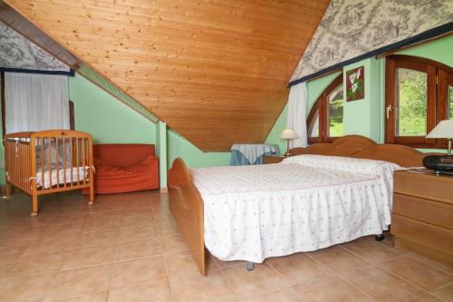 a bedroom with a bed and a crib in it at Villa Ruben in Miengo