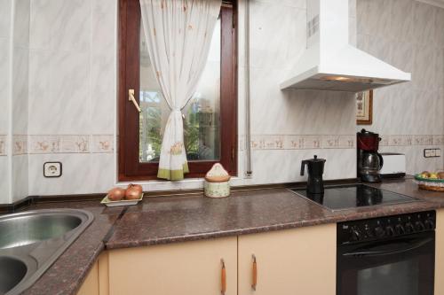 a kitchen with a sink and a window at Villa Ruben in Miengo