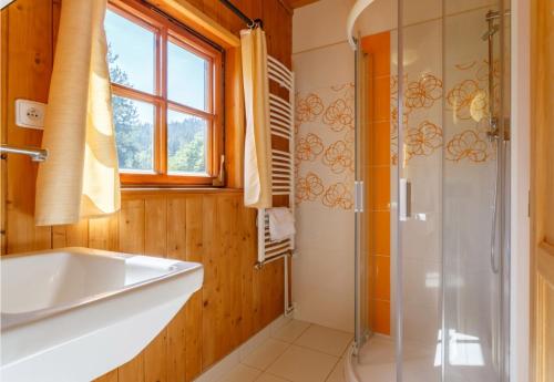 a bathroom with a shower and a tub and a sink at X-Park Františkov in Jindřichov