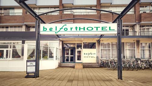 a building with a sign that reads be forhibited at Belfort Hotel in Amsterdam