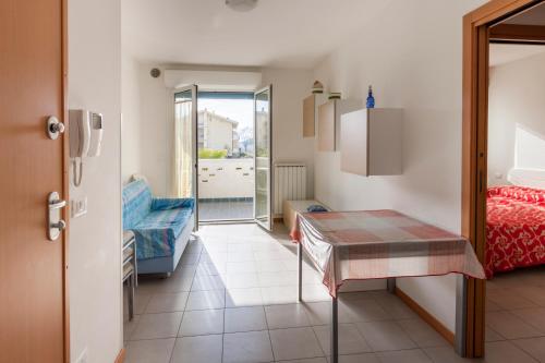 a room with a table and a bed and a door at Residence Palazzo Mediterraneo in Tortoreto Lido