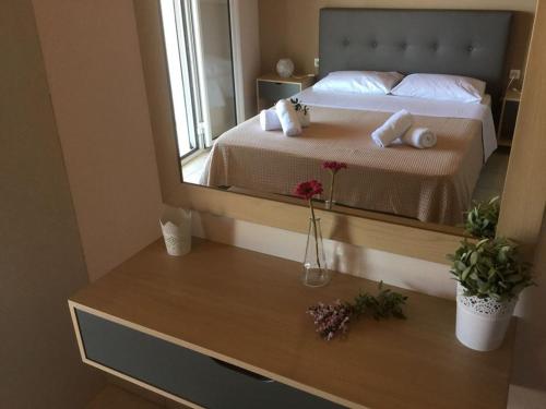a bedroom with a bed with a large mirror at Sea Sound in Vasiliki