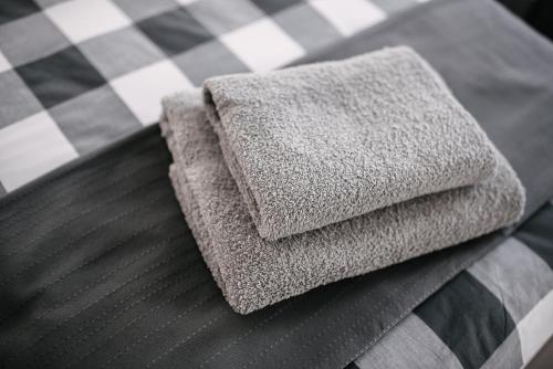 a pile of towels sitting on top of a bed at Apartamenty 1 Maja 45 in Elblag