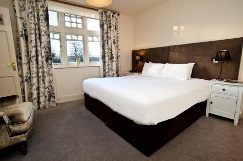 A bed or beds in a room at The Cuckoo Brow Inn