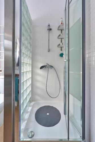 a bathroom with a shower with a glass door at Lisbon Haven - By the METRO with AC in Lisbon