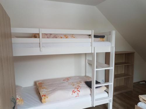 a white bunk bed in a room at Apartmány TAS in Jablonec nad Jizerou