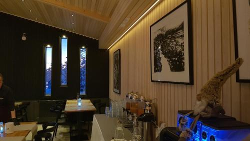 a restaurant with a bar with tables and giraffes on the wall at Santa's Igloos Arctic Circle in Rovaniemi