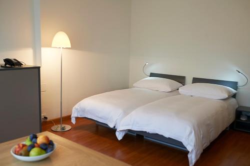 Łóżko lub łóżka w pokoju w obiekcie Congress Apartments by Hotel du Commerce