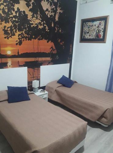 two beds sitting next to each other in a room at Hostal Africa Do Sul in Lisbon
