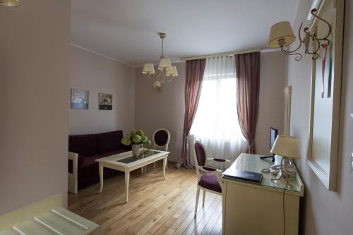 a living room with a couch and a table at Villa Estera - Hotel & Restauracja in Michałowice