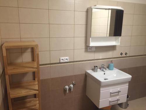 a bathroom with a sink and a mirror at Apartmány TAS in Jablonec nad Jizerou