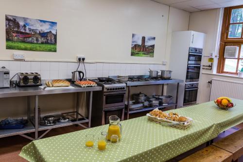 a kitchen with a table with a table cloth on it at Cote Ghyll Mill at Osmotherley in Osmotherley