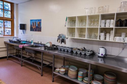 a kitchen with a sink and a counter with dishes at Cote Ghyll Mill at Osmotherley in Osmotherley