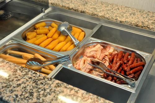 a tray of food with sausages and other foods at Potaissa Hotel in Turda