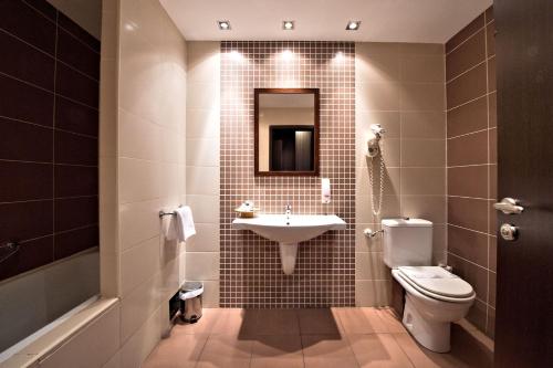 a bathroom with a sink and a toilet at Hotel Aurelia in Timişoara