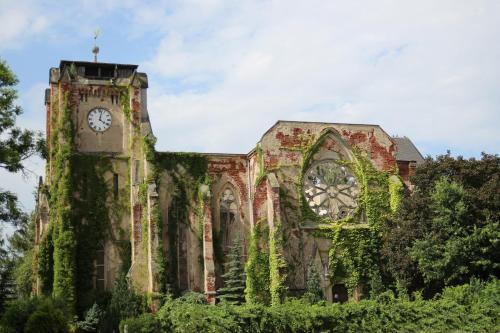 an old building with a clock tower on it at Ferienhaus Kaiserhof in Markkleeberg