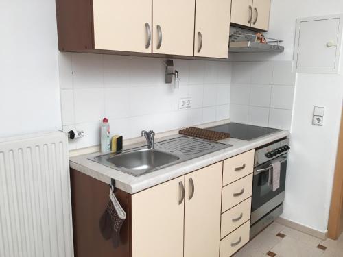 a kitchen with a sink and a stove at EMC Maisonette in Aidlingen