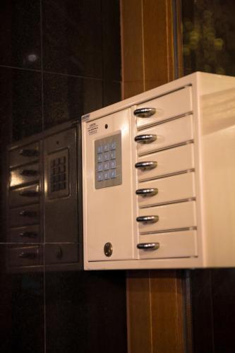 a microwave oven is attached to a wall at Hotel Krona Domžale in Domžale