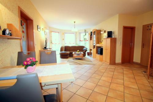a living room with a table and a couch at Feriendomizil am Hafen in Zingst