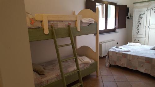 a room with three bunk beds in a room at B&B Podere Montese in Villafranca in Lunigiana