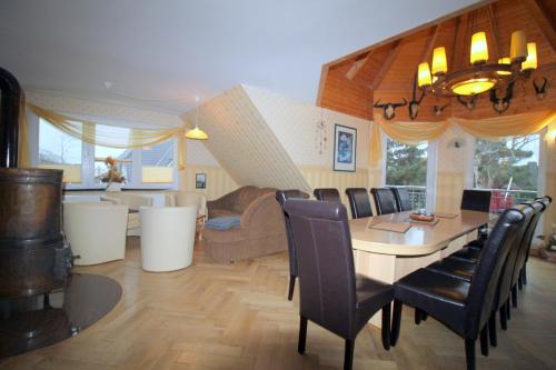 a dining room and living room with a table and chairs at Feriendomizil am Hafen in Zingst