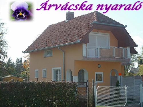 a house with a purple flower on top of it at Árvácska Nyaraló in Balatonmáriafürdő