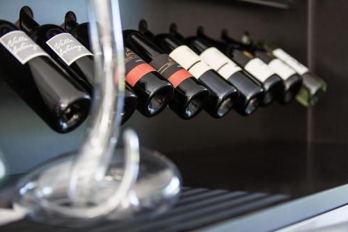 a bunch of wine bottles in a wine rack at Villa Weingarten in Caldaro