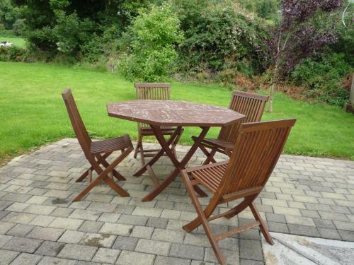 a wooden table with two chairs and a table and chairs at Innisfallen Holiday Homes by Trident Holiday Homes in Killarney