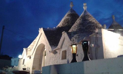 a white building with a parking meter in front of it at Trullo Le Tre Sorelle in Cisternino